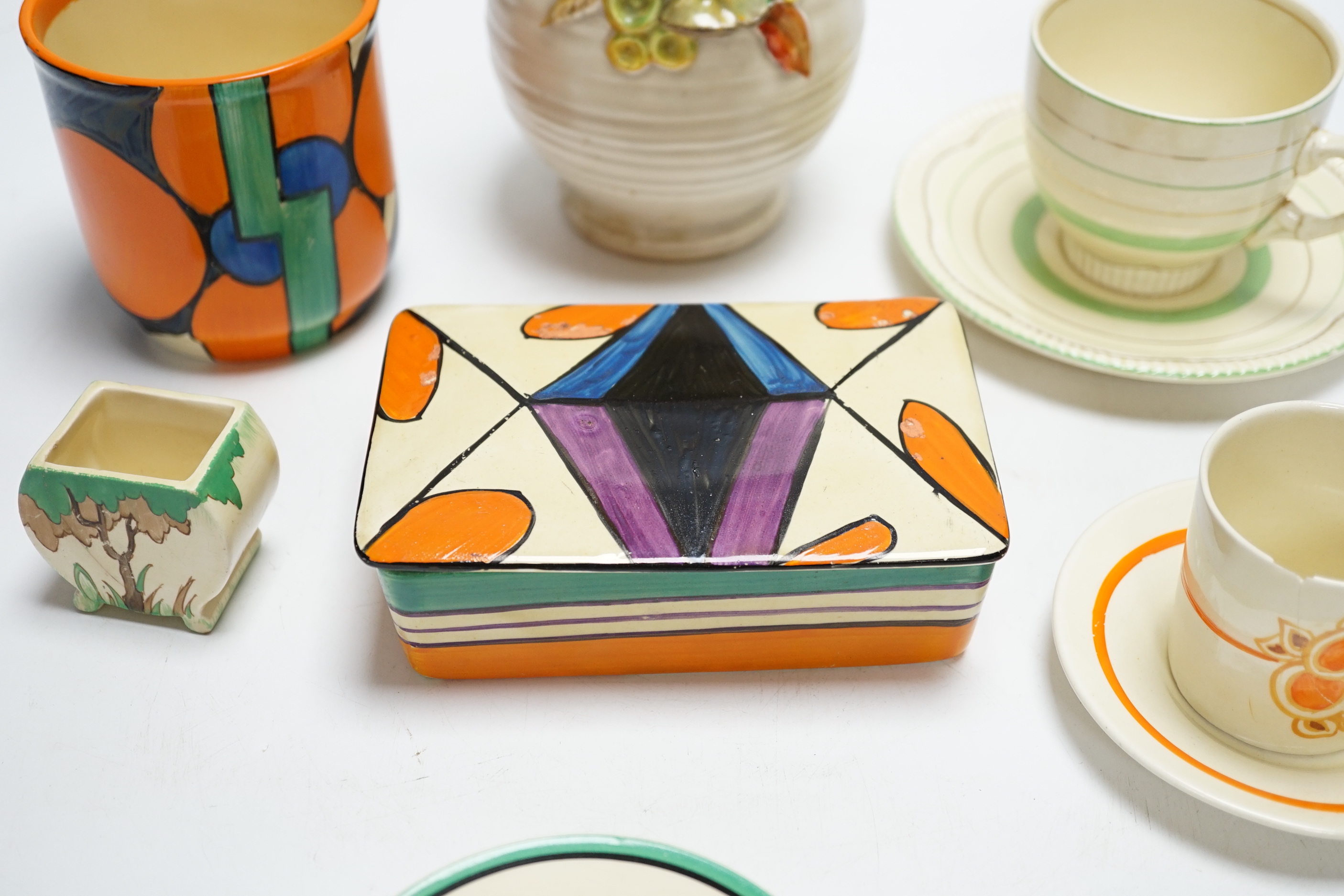 A Clarice Cliff Fantasque butter dish and cover, a Bizarre pot and five other Clarice Cliff items, tallest 20.5cm high